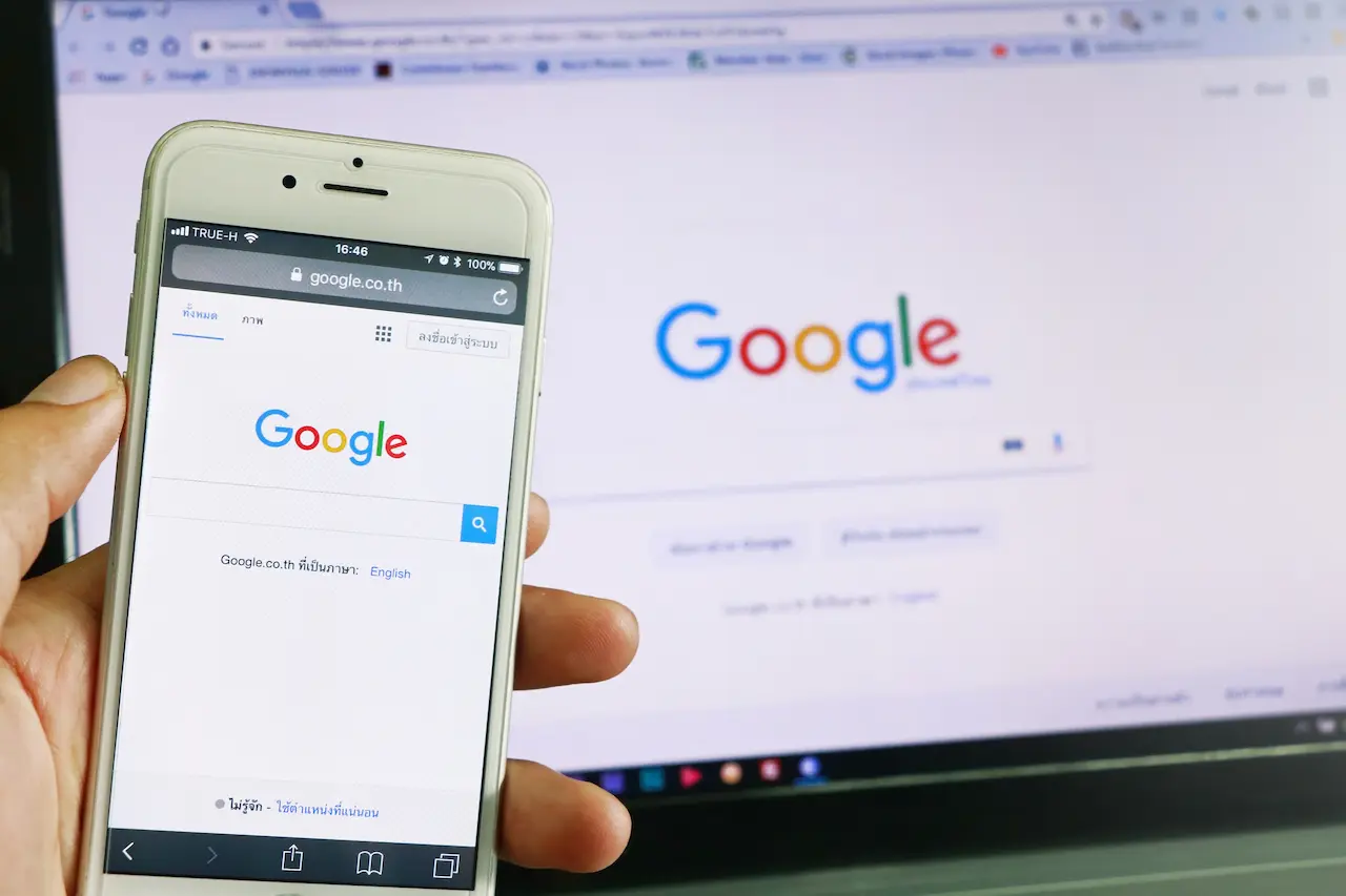 A Smartphone And Computer Running Google Search