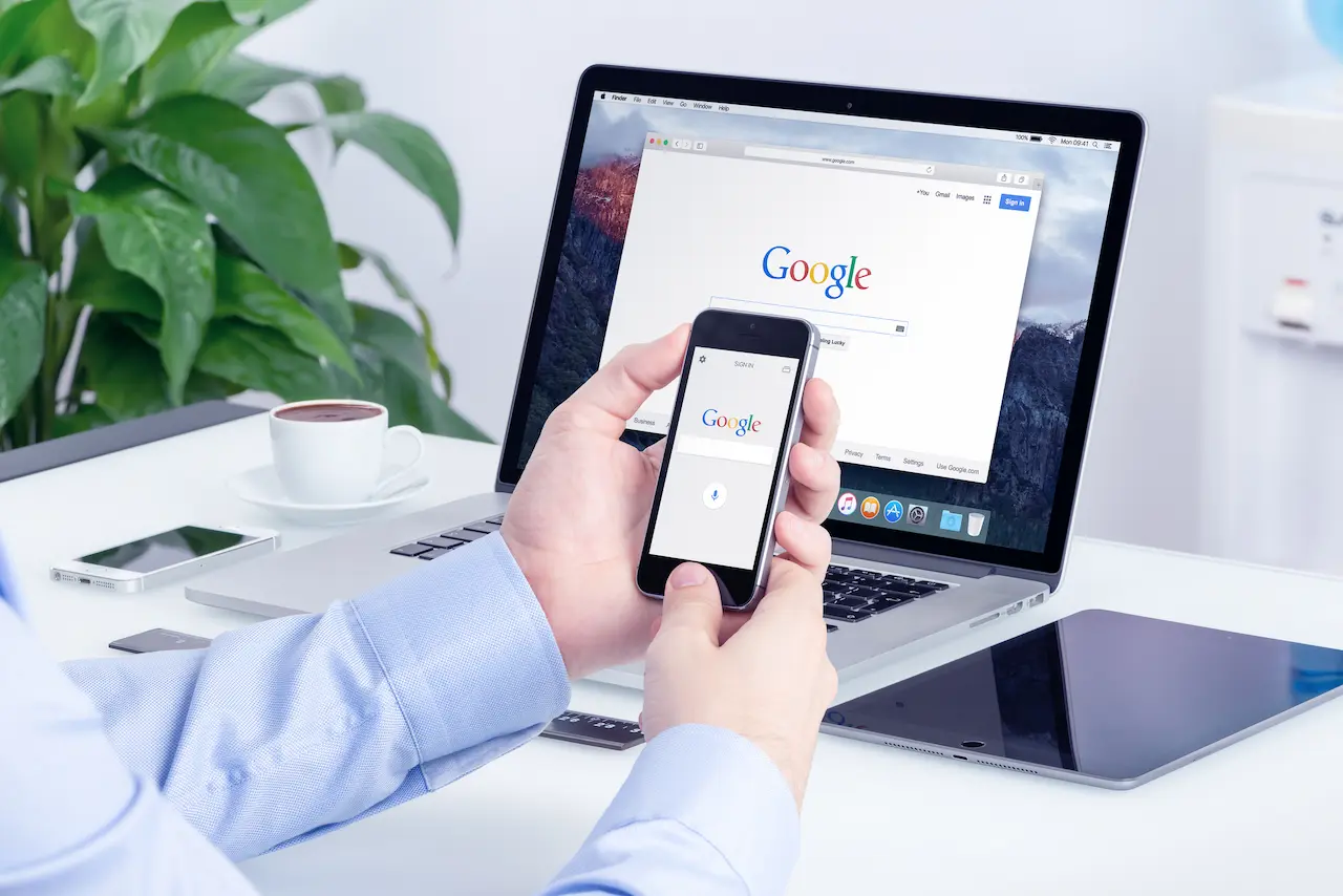 Google Search On Apple iPhone Screen And Macbook Pro