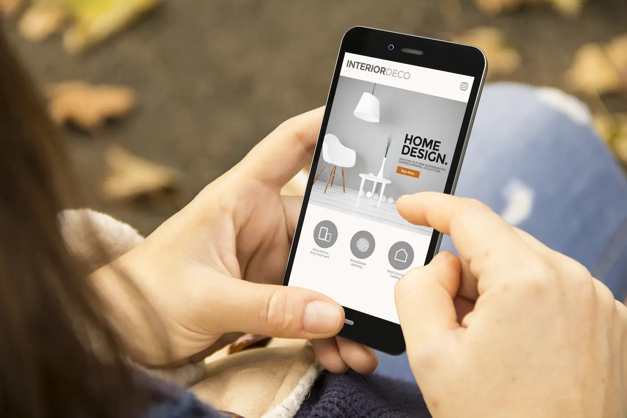 Person Holding A Phone Visiting An Online Business Website