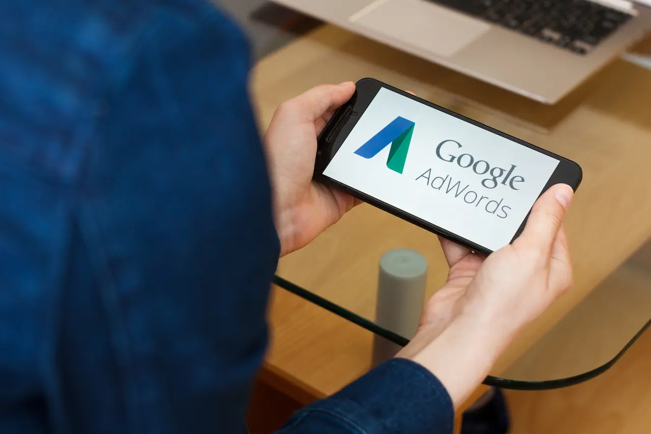 Person Holding A Phone With Google Adwords Logo 